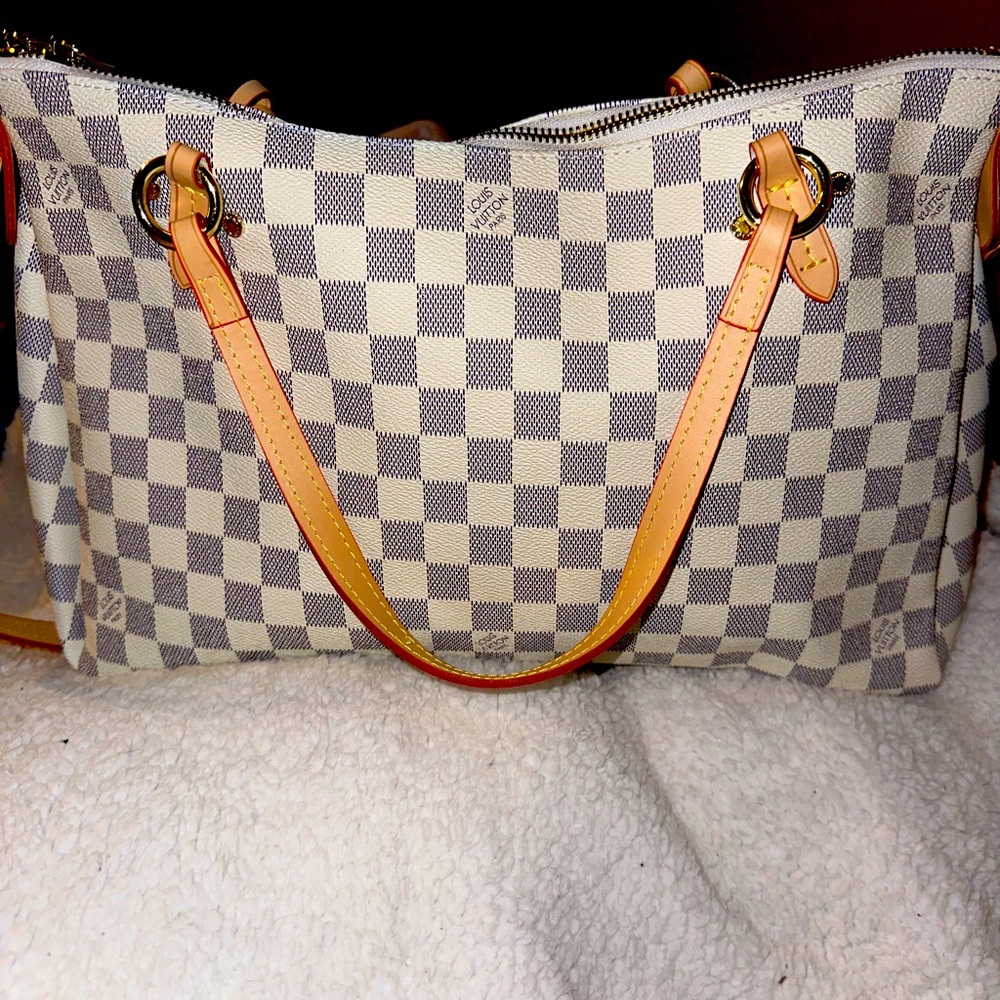Gray/white checkered bag. Long strap and handles, pink interior